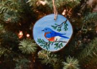 A hand-painted eastern bluebird Christmas ornament available for purchase at Cove Creek Photography.