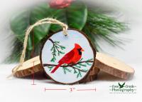 A handmade cardinal wood slice ornament with size dimensions at Cove Creek Photography.