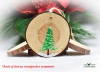A hand-painted evergreen on a wood slice.