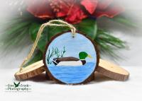A hand-painted wood slice ornament featuring a mallard on blue water that is available at Cove Creek Photography.