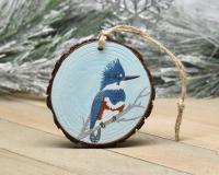 A handmade ornament with a belted kingfisher hand-painted on a a wood slice at covecreekphotography.com.