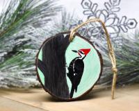 A hand-painted pileated woodpecker on wood slice ornament at covecreekphotography.com.