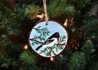 A male rose-breasted grosbeak hand-painted on a pine wood slice available at covecreekphotography.com.