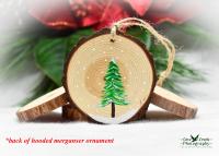 A handpainted evergreen on a wood slice.