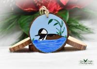 A hand-painted wood slice with a hooded merganser at Cove Creek Photography.