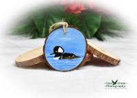 A hand-painted hooded merganser on a wood slice Christmas ornament at covecreekphotography.com