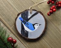 A hand-painted white-breasted nuthatch wood slice ornament at covecreekphotography.com.