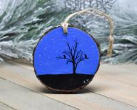A 3.5 inch diameter wood slice with a hand-painted starry night sky and a silhouette of two birds perched in a tree at covecreekphotograpy.com.
