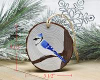 An image of a hand-painted blue jay on a wood slice Christmas ornament with added measurements at Cove Creek Photography.