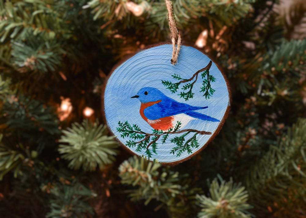 A hand-painted eastern bluebird Christmas ornament available for purchase at Cove Creek Photography.