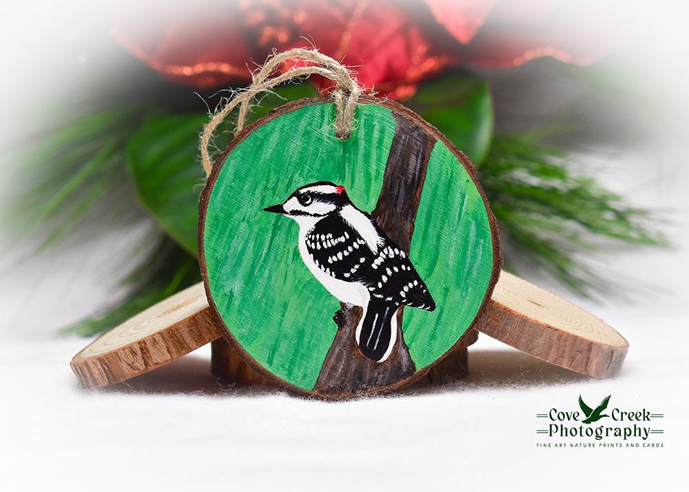 A hand-painted wood slice with a downy woodpecker available at Cove Creek Photography.