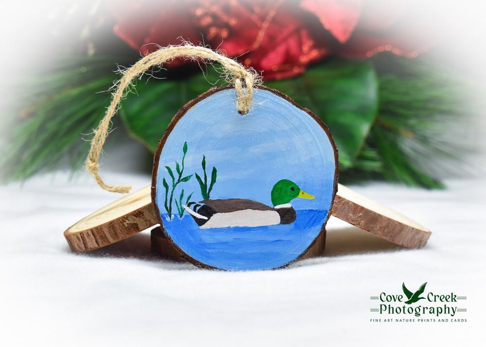 A hand-painted Christmas ornament with a mallard on water offered at Cove Creek Photography.