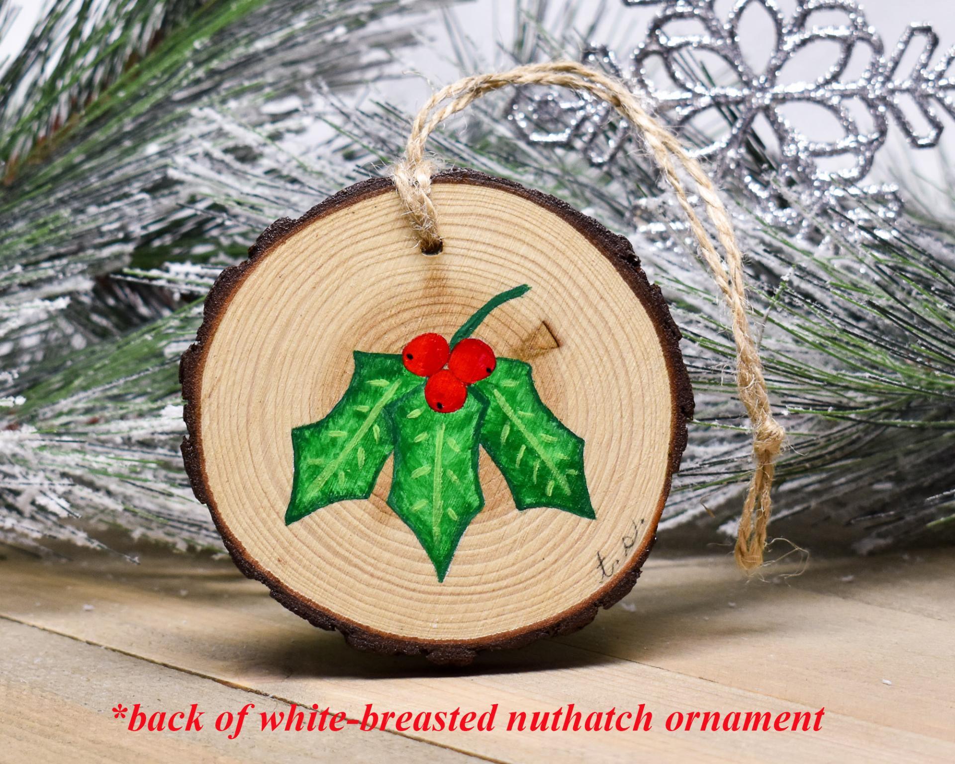 Hand-painted holly leaves and red berries on the back of a handmade ornament at covecreekphotography.com.