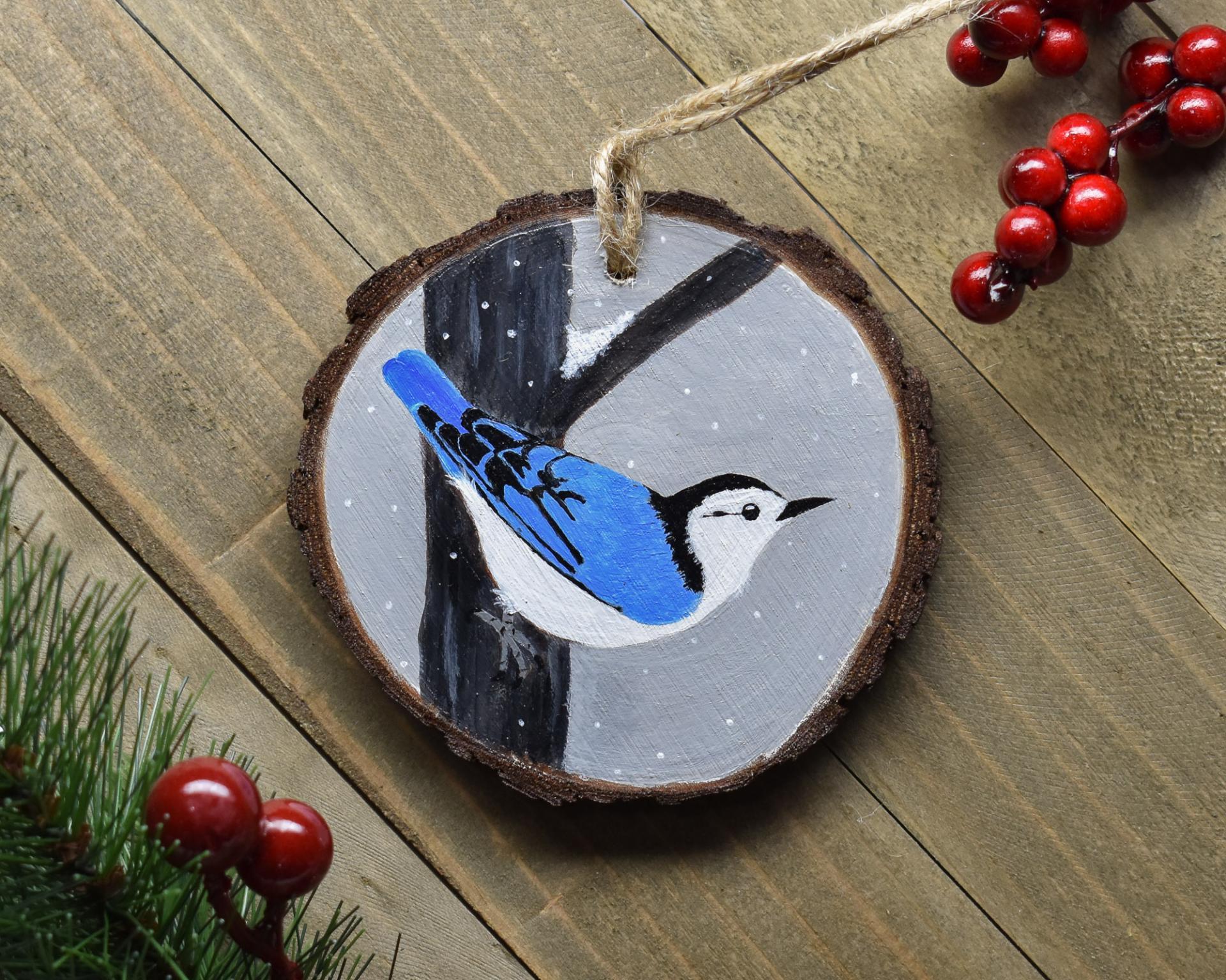 A hand-painted white-breasted nuthatch wood slice ornament at covecreekphotography.com.