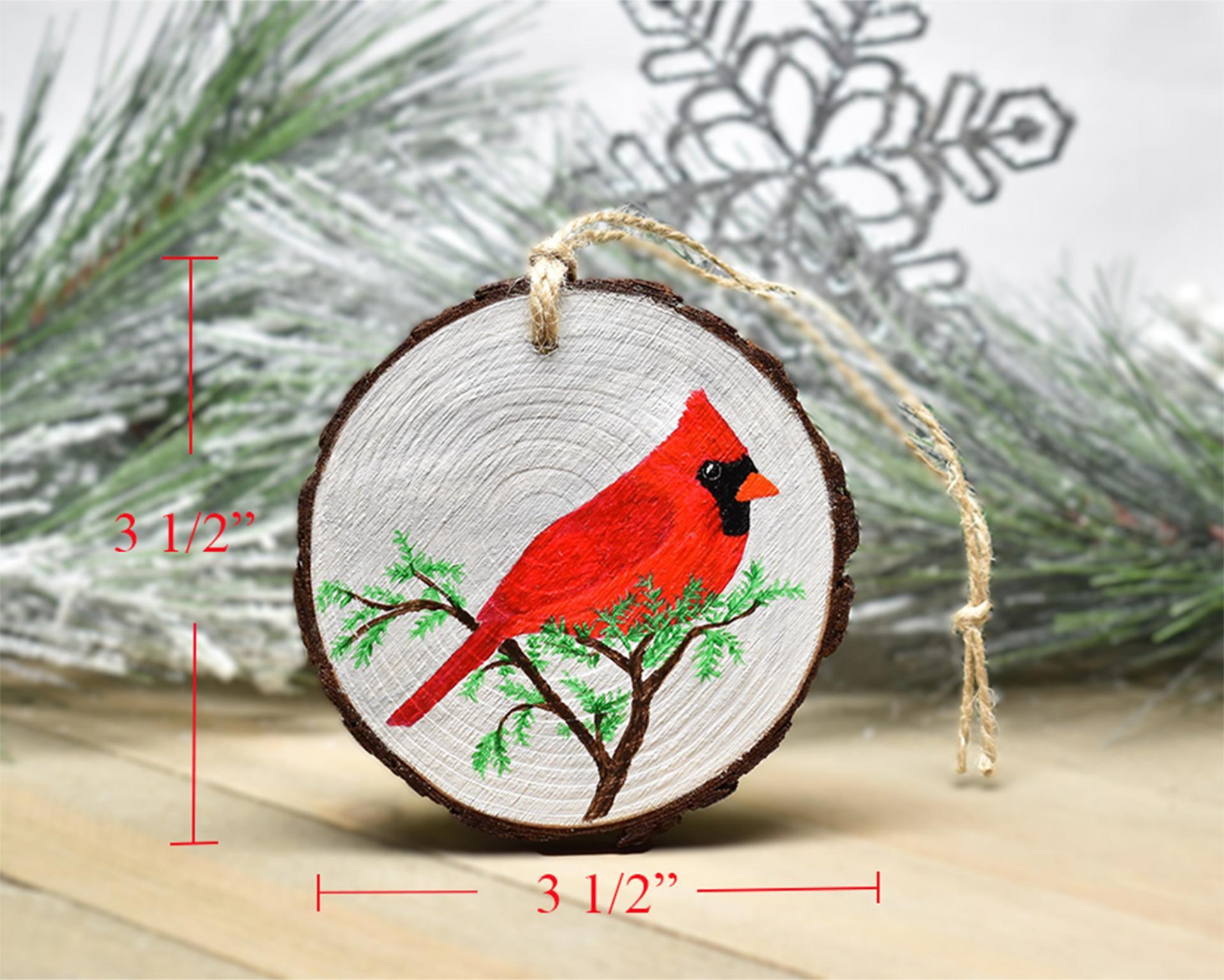 An image of a hand-painted male northern cardinal wood slice Christmas ornament with size measurements displayed on two sides of the wood slice at covecreekphotography.com.