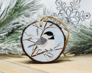 A Carolina chickadee hand-painted on a winter scene wood slice ornament at Cove Creek Photography.